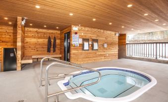 a small indoor pool surrounded by wooden walls , with a blue and white color scheme at Boulder Mountain Resort