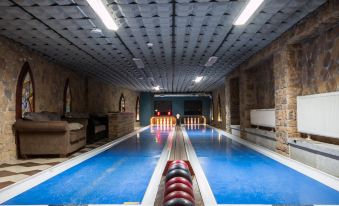 a long , narrow pool with a red ball at the end and neon lights in the background at Gaja