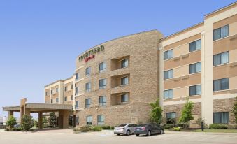 "a large , multi - story hotel with a tan stone exterior and the word "" courtyard "" on top" at Courtyard Lufkin