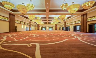 a large , empty ballroom with multiple chandeliers hanging from the ceiling and a red carpet on the floor at The Westin Playa Bonita Panama