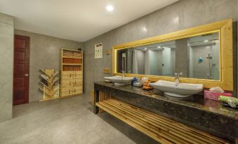 a modern bathroom with two sinks , a mirror , and a wooden bench , as well as shelves for storage at Lake View Hotel