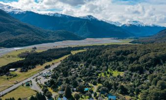 aerial view of a small town surrounded by mountains , with a river running through it at Wonderland Makarora Lodge