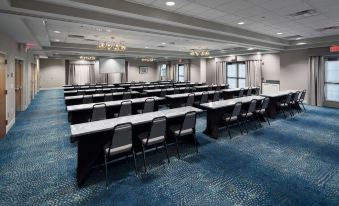 a large conference room with rows of chairs and tables set up for a meeting at Homewood Suites by Hilton Newburgh-Stewart Airport