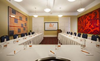 a conference room with a long table and chairs arranged for a meeting or event at LHotel