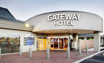 the entrance to the gateway hotel , with a white exterior and large letters above the door at Nightcap at Gateway Hotel