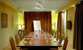 a conference room set up for a meeting , with chairs arranged in a semicircle around a long table at Hotel Brossard