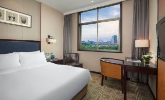 a spacious bedroom with large windows and a double bed in the center at Kasion Purey Hotel (Yiwu International Trade City store)