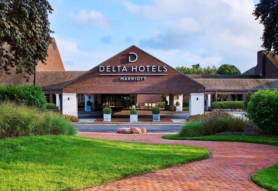 "the exterior of a hotel named "" delta hotels by marriott "" with a large brick building and grassy area in front" at Delta Hotels by Marriott Baltimore Hunt Valley