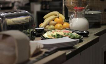 a dining table with a variety of food items , including fruits , vegetables , and other dishes at The Orange Tree Thornham