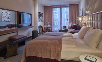 a hotel room with two beds , one on the left and one on the right side of the room at Adina Apartment Hotel Nuremberg