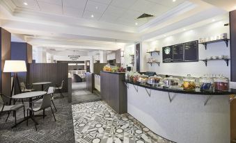 a hotel lobby with a check - in desk and a food area , providing a comfortable environment for guests at Doubletree by Hilton Dartford Bridge