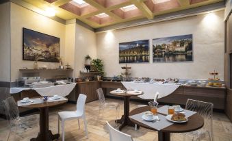 a modern , well - lit restaurant with wooden tables and chairs , a large window , and paintings on the walls at Hotel Plaza