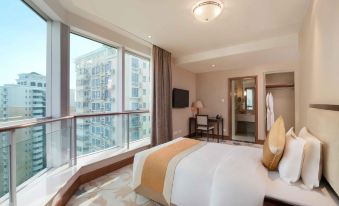 The king-size bed in this bedroom offers a view of the city through large windows and a balcony at Metropark Jichen Hotel Shanghai