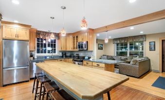 a large , open kitchen with wooden cabinets and a center island is shown in the image at Top Notch Inn