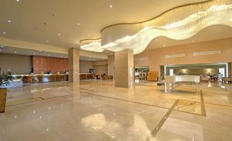 a large hotel lobby with marble floors , high ceilings , and a large chandelier hanging from the ceiling at Marino Beach Colombo