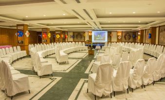 a large conference room with white chairs arranged in rows , ready for a meeting or event at Ekante Bliss Tirupati - Ihcl SeleQtions
