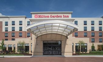 a large hotel entrance with a hilton garden inn sign above the door , and an arched doorway leading to the building at Hilton Garden Inn Akron