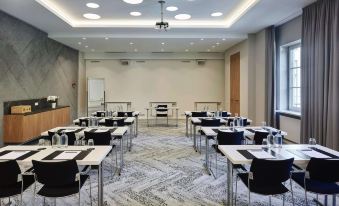 a conference room with rows of chairs arranged in a semicircle , and a podium at the front of the room at Steigenberger Hotel and Spa, Krems