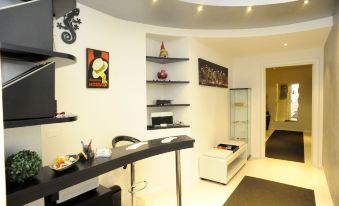 a modern living room with a black bar and shelves , featuring framed art on the wall at Magic Rainbow