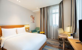 Our window overlooks a bedroom with a double bed and a large table for the day at Holiday Inn Express Shanghai Zhenping