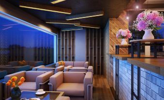 a modern bar with wooden walls , a sleek bar counter , and comfortable seating arrangements with floral arrangements at Gold Hotel Hue