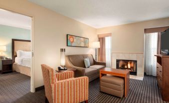 a living room with a couch , chairs , and a fireplace in front of a window at Homewood Suites by Hilton Columbus - Hilliard