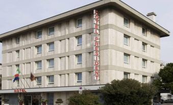 "a large white building with a sign that reads "" hotel everest international "" prominently displayed on the front of the building" at Hotel President