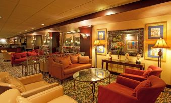a well - decorated living room with multiple couches and chairs , creating a warm and inviting atmosphere at Holiday Inn Johnstown-Downtown