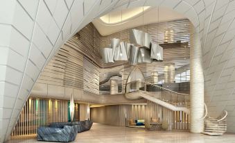 a modern hotel lobby with a staircase leading up to the second floor , where a staircase is visible at DoubleTree by Hilton Ahmedabad