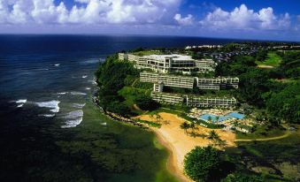a resort with a pool is situated on a cliff overlooking the ocean , and overlooks the ocean at 1 Hotel Hanalei Bay