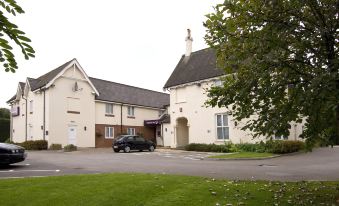 a two - story white house with a large window and a car parked in front of it at Taunton Ruishton (M5, J25)