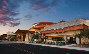a large building with a restaurant in front of it , surrounded by a parking lot at Gila River Resorts & Casinos – Vee Quiva