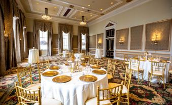 a large dining room filled with tables and chairs , ready for a formal event or a wedding reception at Bourbon Orleans Hotel