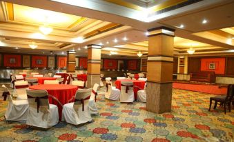 a large , elegant banquet hall with multiple dining tables and chairs set up for a formal event at Hotel Shangri la