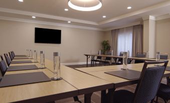 a conference room with multiple tables , chairs , and glasses set up for a meeting or presentation at Hampton Inn Hallandale Beach-Aventura