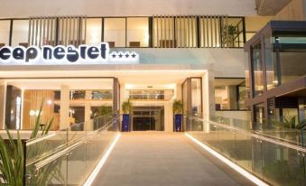 "the entrance to a hotel with a sign that says "" nestel "" and a glass railing" at Hotel Cap Negret