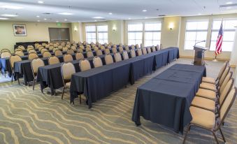 a large conference room with multiple rows of tables and chairs arranged for a meeting at Catalina Canyon Inn