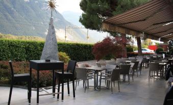 an outdoor dining area with tables and chairs set up for guests to enjoy a meal at Hotel du Soleil