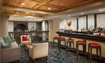a modern lounge area with a bar , chairs , and couches is shown in this image at The Terrace Hotel Lakeland, Tapestry Collection by Hilton