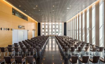 a large conference room with rows of chairs arranged in a semicircle , ready for a meeting at NH Den Haag