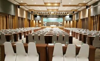 a large conference room with rows of chairs arranged in a semicircle , creating an intimate setting for a meeting or event at Siva Royal Hotel
