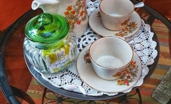 a tray with a teapot , cups , and saucers on a table in a living room at CasAda