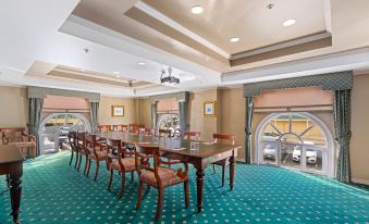 a large conference room with a long table and multiple chairs , all facing a window at Hotel Grand Chancellor Launceston