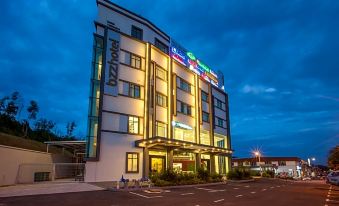 "a modern hotel building with multiple lights and a sign that reads "" hilton garden inn "" on the front" at Bzz Hotel Skudai