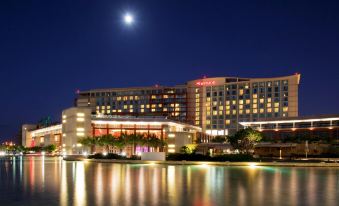 a large hotel with a crescent moon in the sky and lights reflecting on the water at Sheraton Puerto Rico Resort & Casino