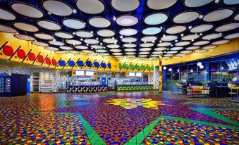 a colorful room with a floor and ceiling covered in multi - colored tiles , creating a vibrant atmosphere at Disney's Pop Century Resort - Classic Years