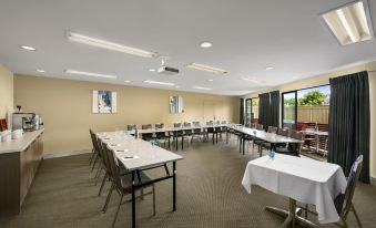 a large conference room with multiple tables and chairs arranged for a meeting or event at Quest Bendigo Central