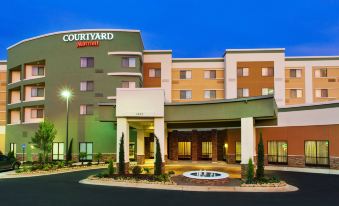the courtyard by marriott hotel is a modern , well - lit building with multiple stories and entrances at Courtyard Columbus Phenix City/Riverfront