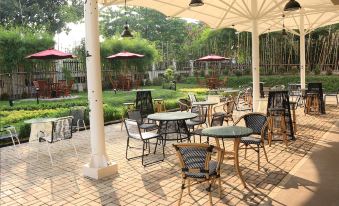 an outdoor dining area with a variety of chairs and tables , creating a pleasant atmosphere for guests at Java Palace Hotel