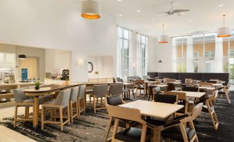 a large , modern dining room with multiple tables and chairs arranged for a group of people to enjoy a meal together at Homewood Suites by Hilton Salt Lake City Draper
